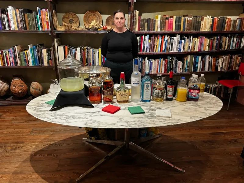 Bartender preparing drinks at a warm event bar.